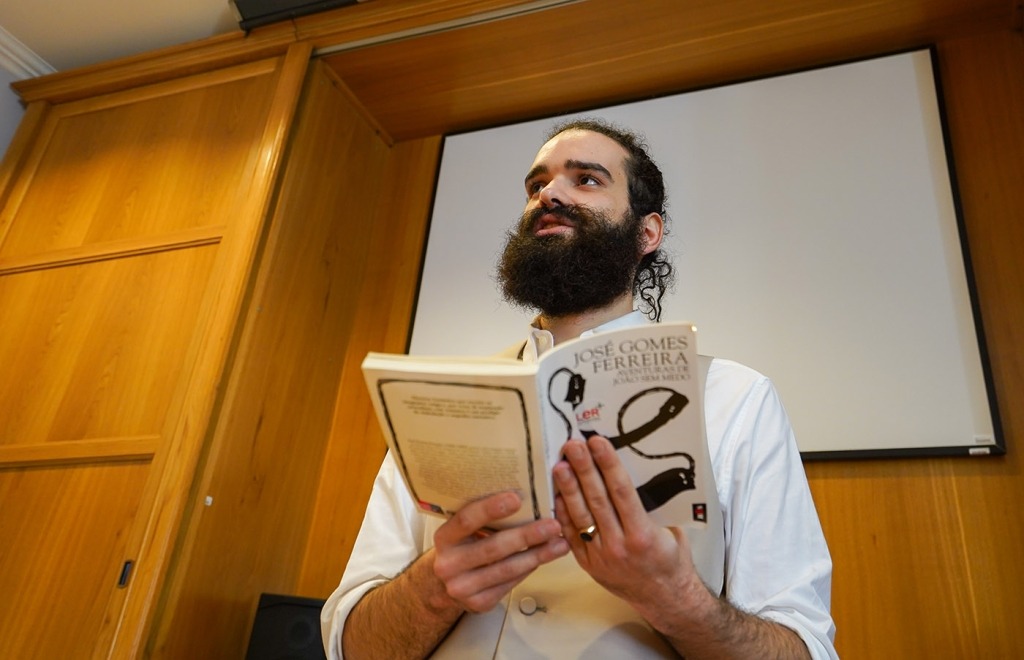 Um senhor com barba lê um livro